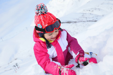 Little girl with pink outfit playing in the snow © goodluz