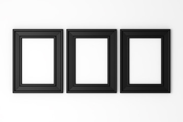 three blank black photo frames on white wall