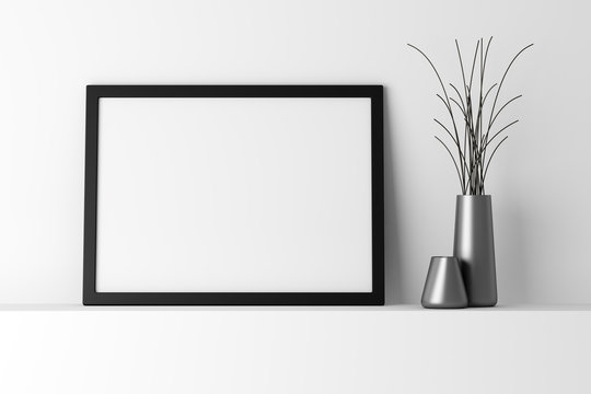 blank black photo frame on white shelf