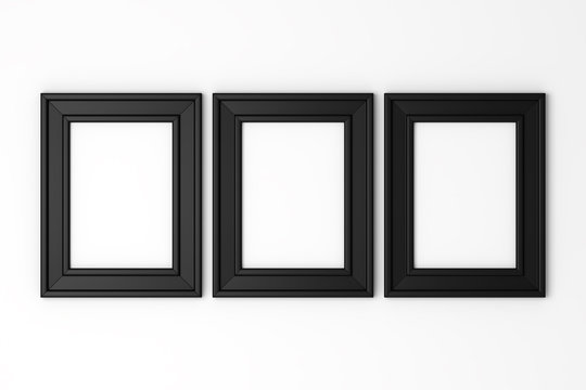 Three Blank Black Photo Frames On White Wall