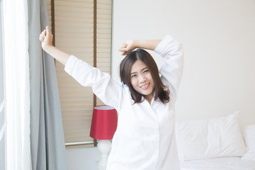 Fototapeta premium Young asian woman stretching in the morning
