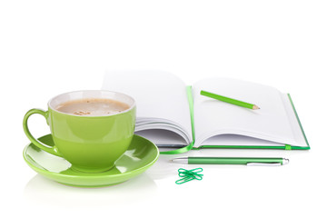 Green coffee cup and office supplies