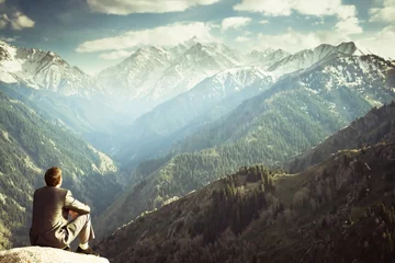Foto op Canvas zakenman op de top van de berg zitten en denken © petunyia