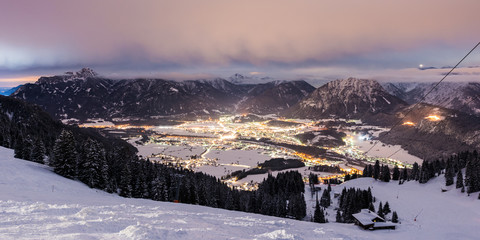 view from mountain to illuminated valley at winter