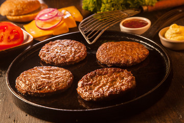 Preparing a batch of cheeseburgers