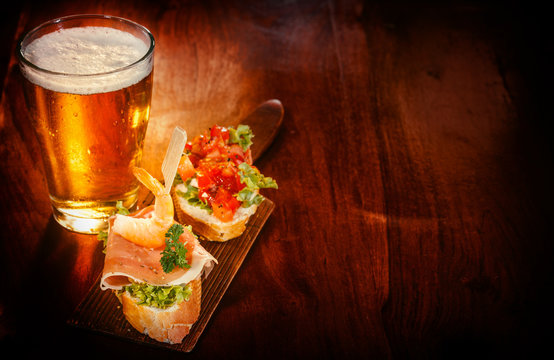 Glass of beer with delicious tapas