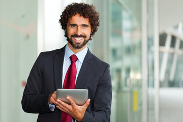 Businessman using his tablet computer