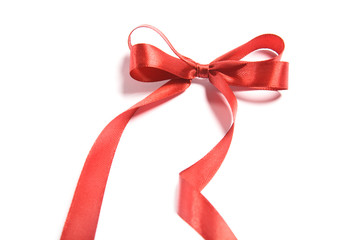 Shiny red satin ribbon and bow on white background