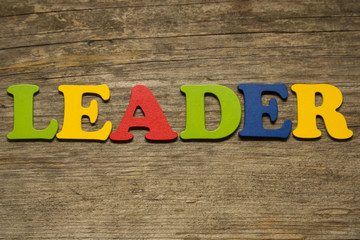 word leader on a wooden background