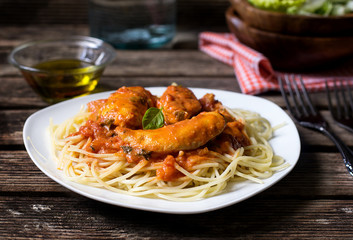 Chicken breasts in tomato and cream sauce with pasta
