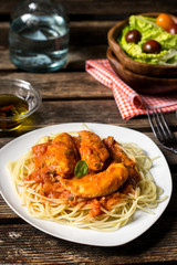 Chicken breasts in tomato and cream sauce with pasta