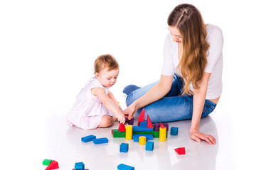 Beautiful baby with mother building with cubes