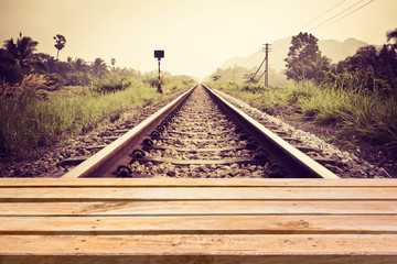 Empty wooden deck table on vintage railroad