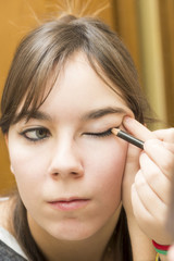 woman applying makeup eyes