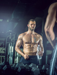 Fototapeta na wymiar Man drinking water in gym