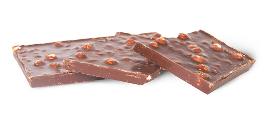 Several pieces of dark chocolate with hazelnuts