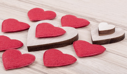 Obraz premium valentine's fabric and wooden hearts on a wooden background