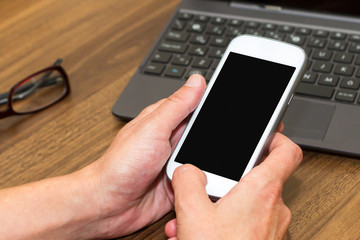 Business woman using smart phone with blank screen.
