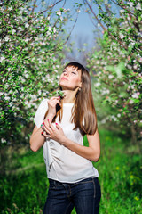 Beautiful woman on the garden with blossom trees
