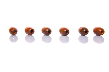 Brown round wooden beads over white background