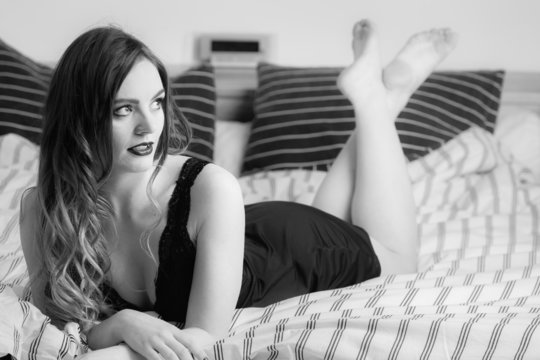 Sexy posing woman in bedroom.