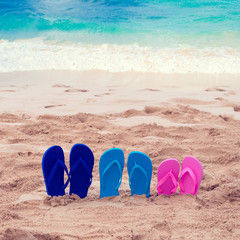 Fototapeta premium Color Flip flops next to ocean