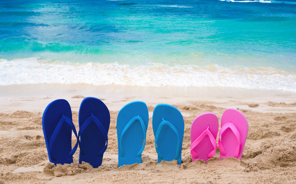 Color Flip flops next to ocean
