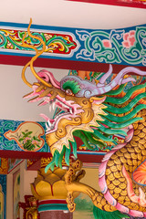 Dragon head sculpture on wall of temple in Thailand