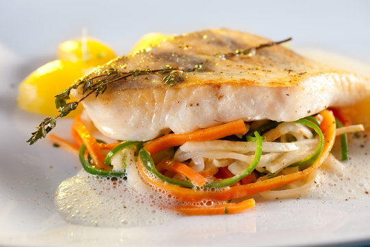 Fried pike perch fillet with vegetables.