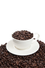 Roasted coffee beans with a cup