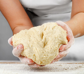 Woman Hands holding a  fresh dough.