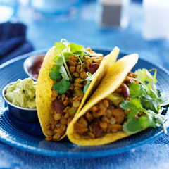 vegan lentil tacos with cilantro and guacamole on the side
