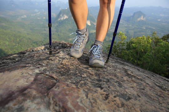 woman hiker enjoy the view on mountain peak rock 