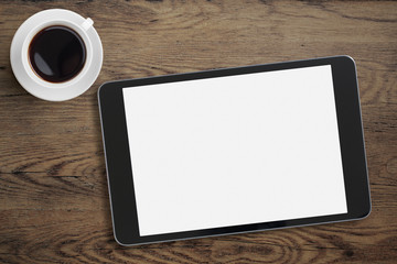 Black tablet pc or ipad on table desk with coffee cup