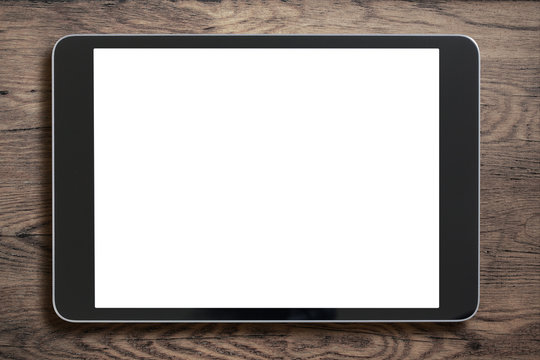 Black Tablet Pc Or Ipad On Old Wood Background