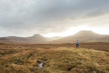 Man standing in Scottish Highland landscape