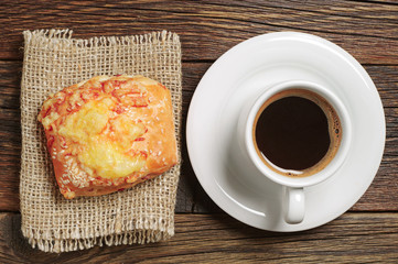Coffee and fresh bun with cheese