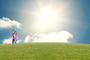 Composite image of couple hugging and holding brush