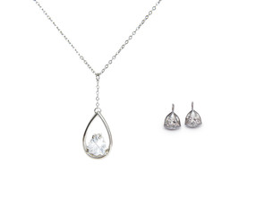 beautiful silver necklace and diamond earrings isolated on white