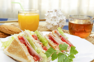 Huge breakfast with sandwich, orange juice, sweet and tea