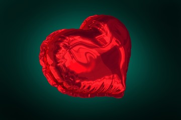 Red heart balloon against green background