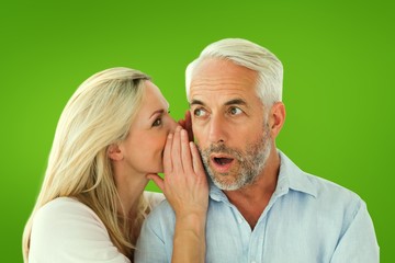 Composite image of woman whispering a secret to husband