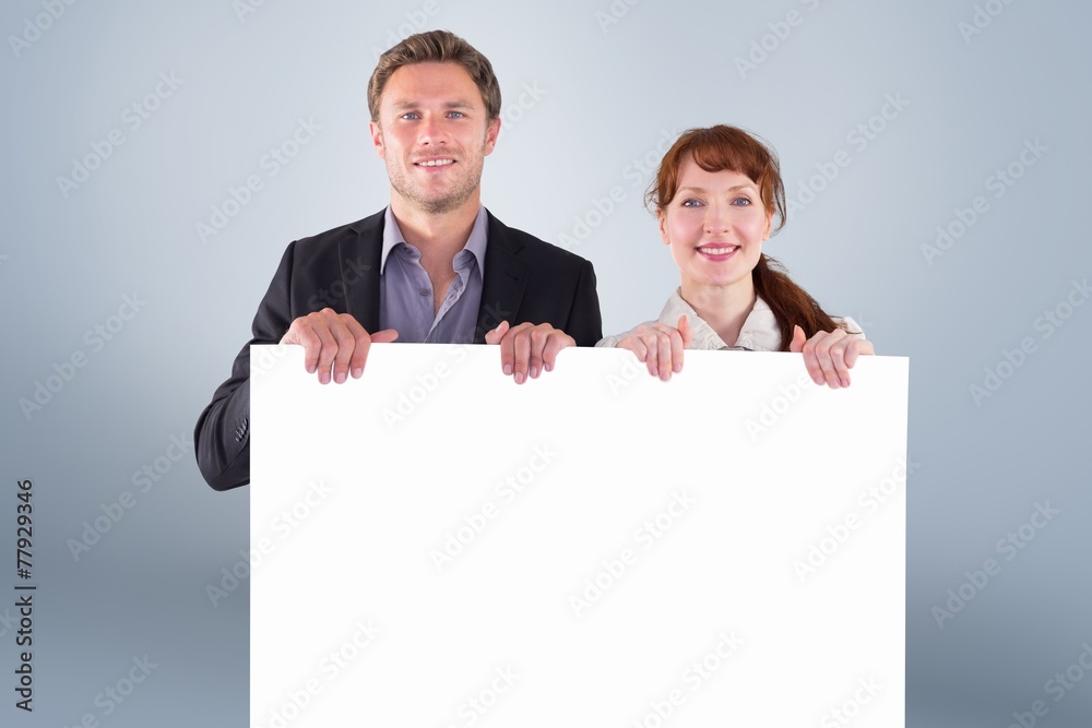 Poster composite image of smiling couple holding large sign