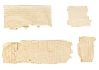 Torn scraps from cardboard box with copy-space isolated on white