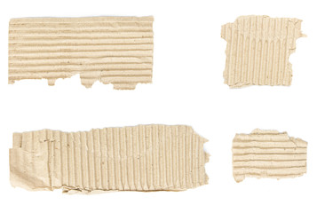 Torn scraps from cardboard box with copy-space isolated on white