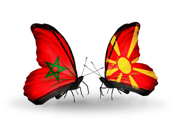 Fototapeta na wymiar Two butterflies with flags Morocco and Macedonia