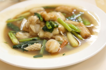 Thai food Wide Noodles in a Creamy Sauce with seafood