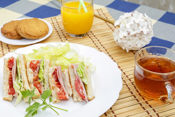 Huge breakfast with sandwich, orange juice, sweet and tea