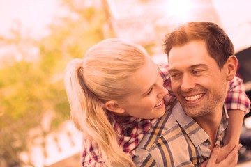 Fototapeta premium Man giving his pretty girlfriend a piggy back