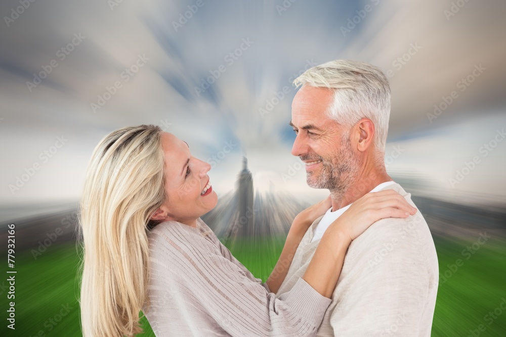 Aufkleber Composite image of happy couple standing and hugging